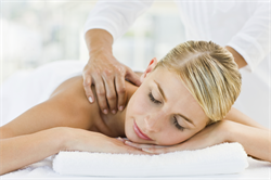 Blonde woman getting shoulder massage at Genesis Career College